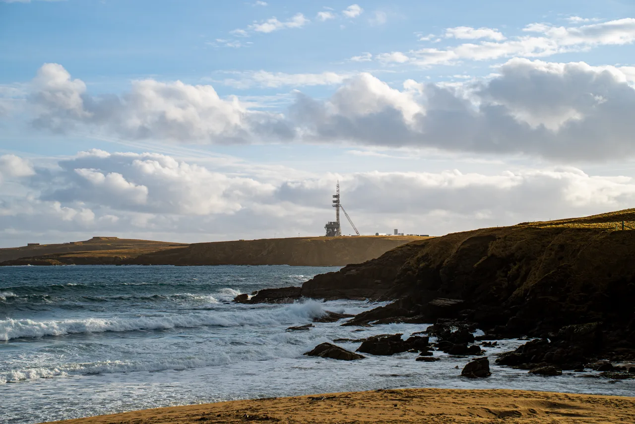 RFA launch tower at SaxaVord Spaceport on the coast of Unst, seen from a beach